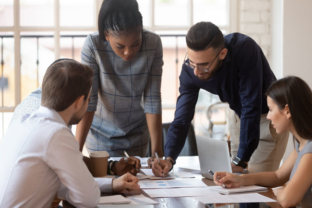Team of people collaborating around a table